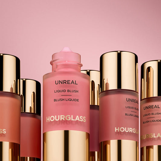 Luxurious pink and rosy liquid blush bottles with gold caps, displaying creamy, dewy textures.
