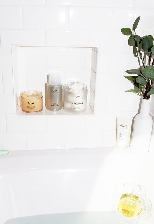 Bottle of Scalp, Hair and Body Scrub & Other Body Products in Bath Tub