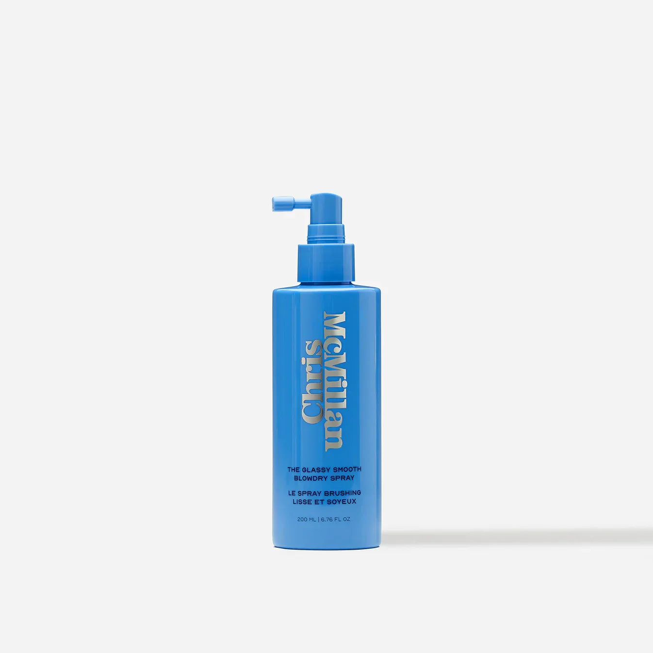 Luxurious blue blowdry spray bottle with glossy finish and minimalist design on white background