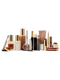 Luxurious assortment of makeup and skincare products in gold and neutral packaging with creamy, dewy, and glossy finishes.