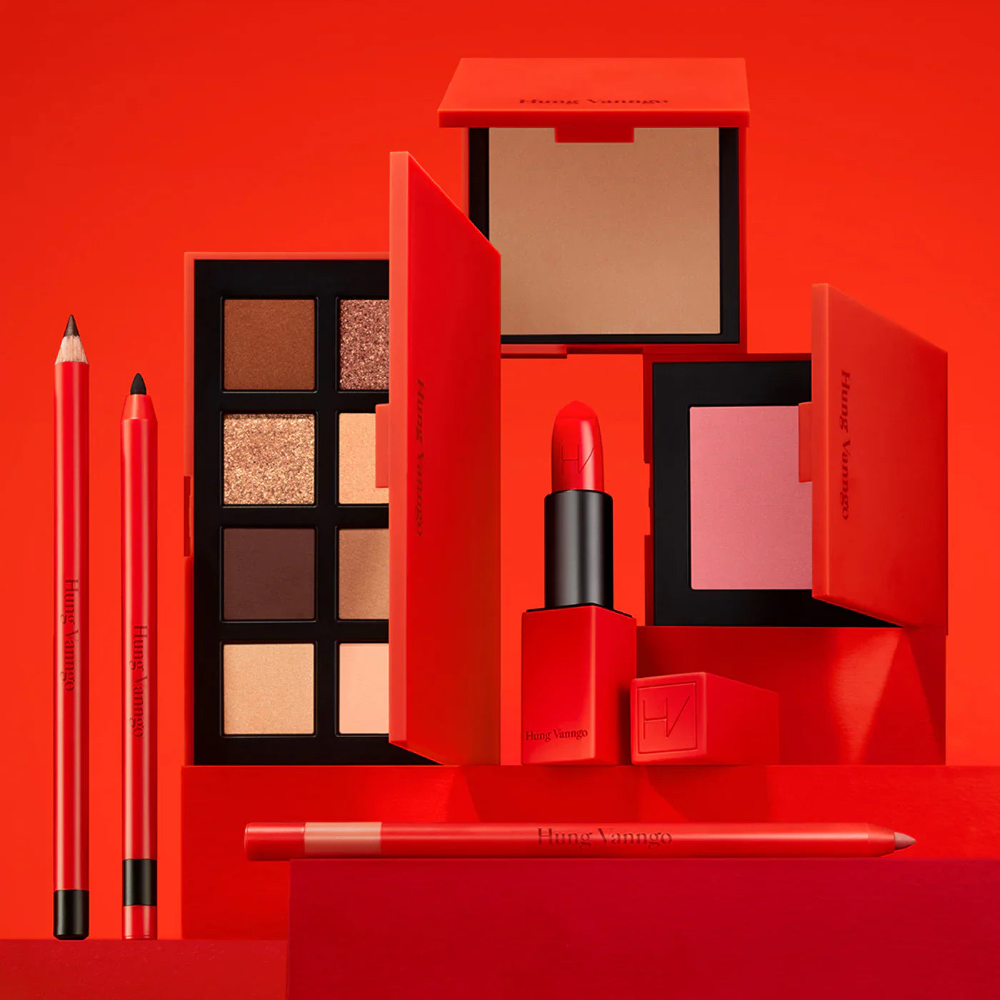 Hung Vanngo makeup collection with red packaging, eyeshadow palette, lipstick, pencils