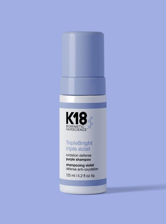 Luxurious K18 TripleBright purple shampoo in sleek lavender bottle, glossy finish, minimalist backdrop.