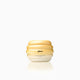 Luxurious honey-colored hair mask jar with glossy finish and gradient yellow design on white background