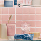 Summer Fridays skincare products with pink and blue packaging in a chic bathroom setting