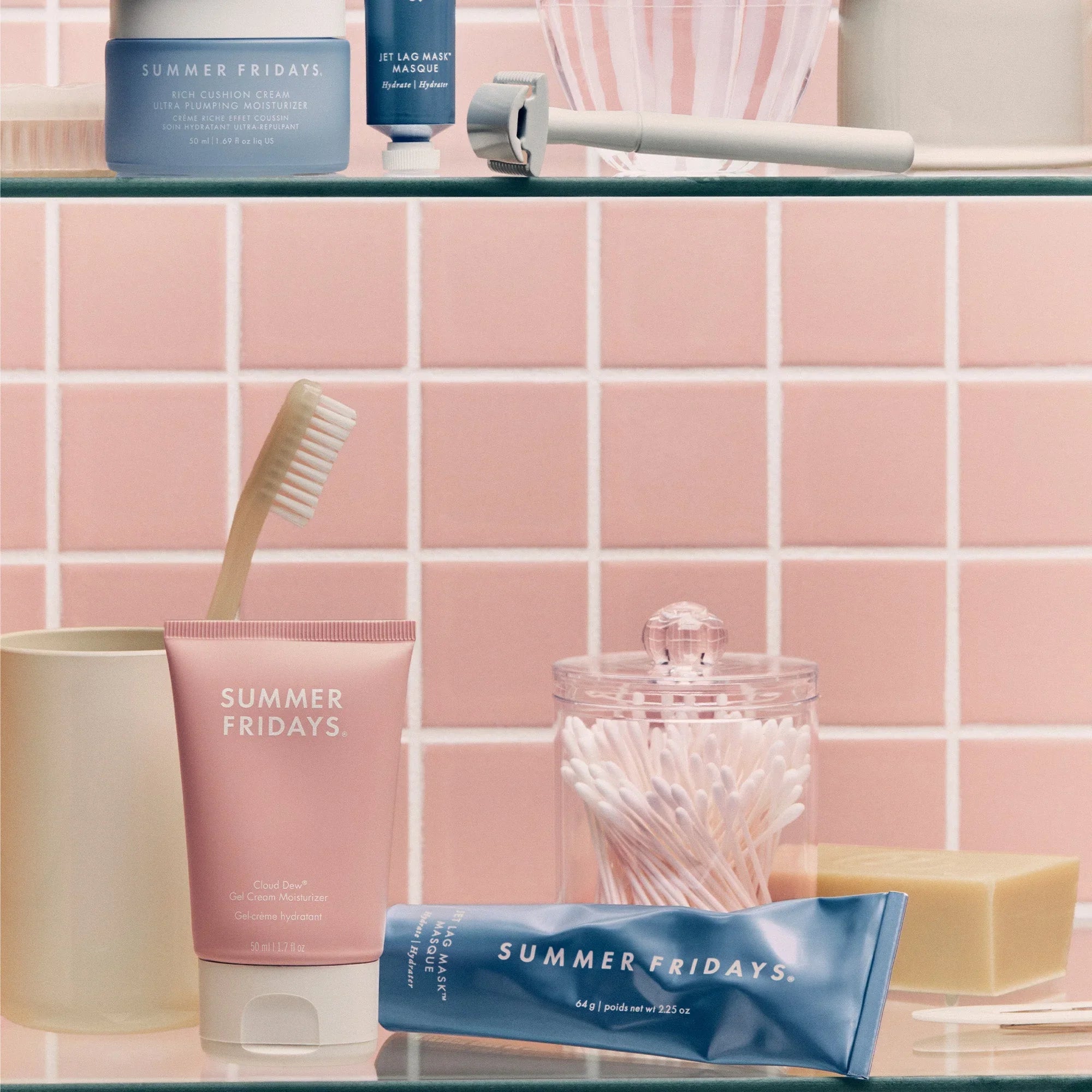 Summer Fridays skincare products with pink and blue packaging in a chic bathroom setting