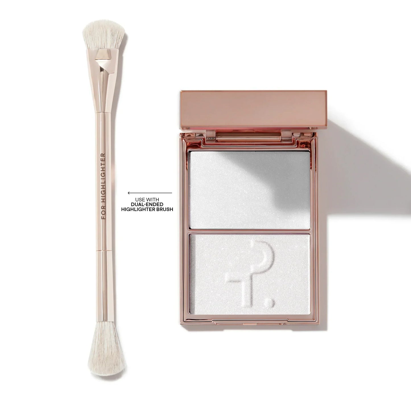 Luxury dual-ended highlighter brush and shimmery white powder highlight palette in rose gold case.
