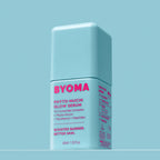 A bottle of Byoma Phyto-Mucin Glow Serum with a soft blue background.
