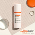 BeautyStat Universal C Skin Refiner serum bottle on grid paper with glossy liquid drops, luxury skincare