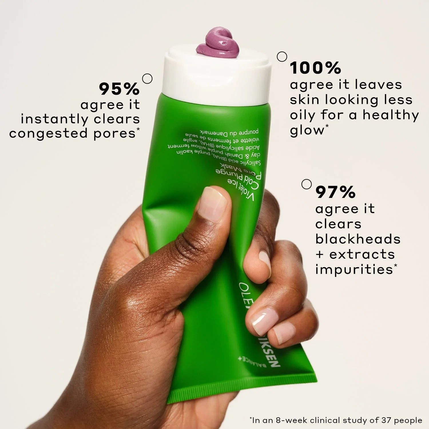 Hand holding a green tube of skincare mask with creamy purple texture and key benefits listed.