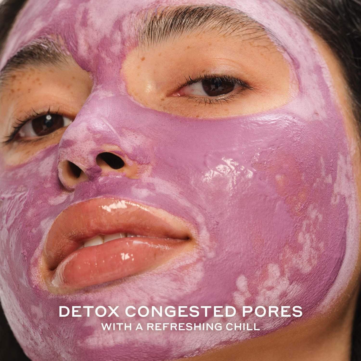 Close up of a woman wearing a creamy purple face mask with a dewy finish, Wylde Grey skincare