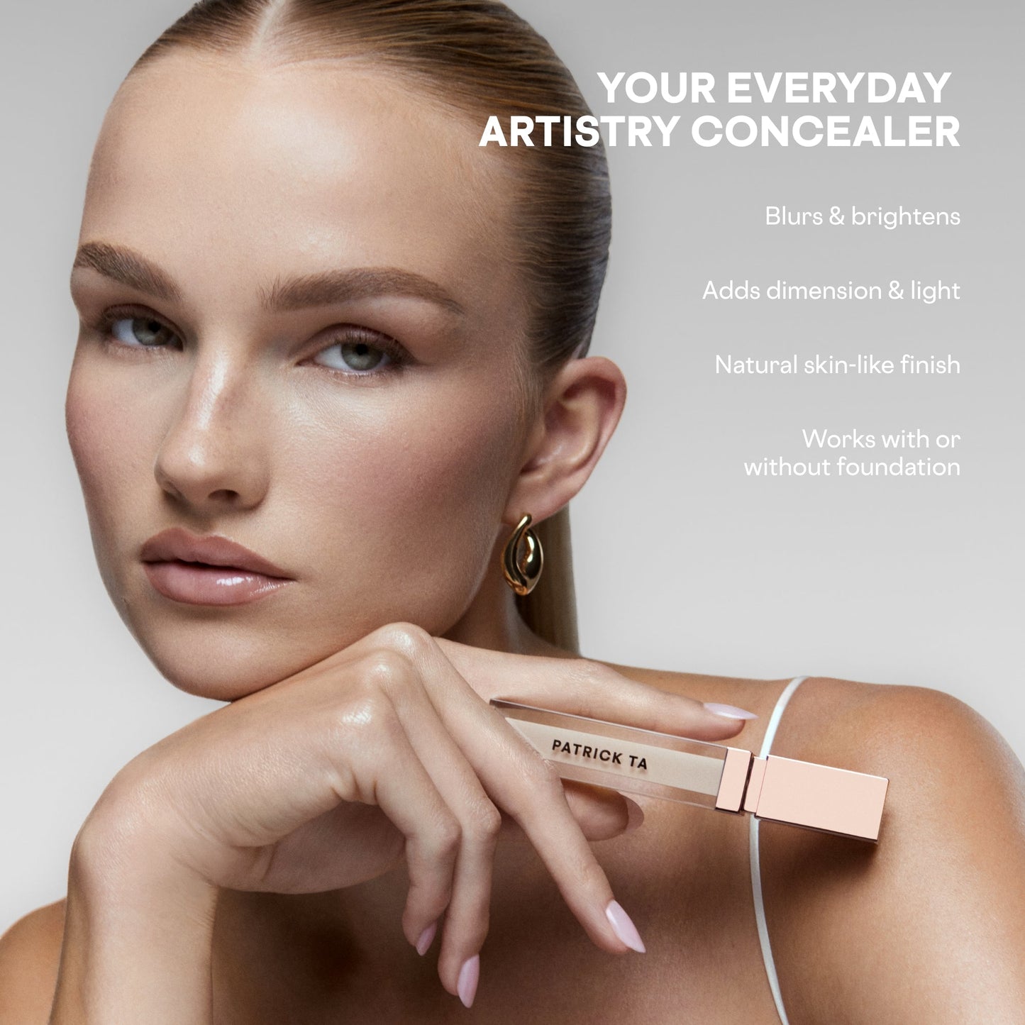 Model with flawless, radiant skin holding PATRICK TA concealer in soft beige, creamy texture visible.