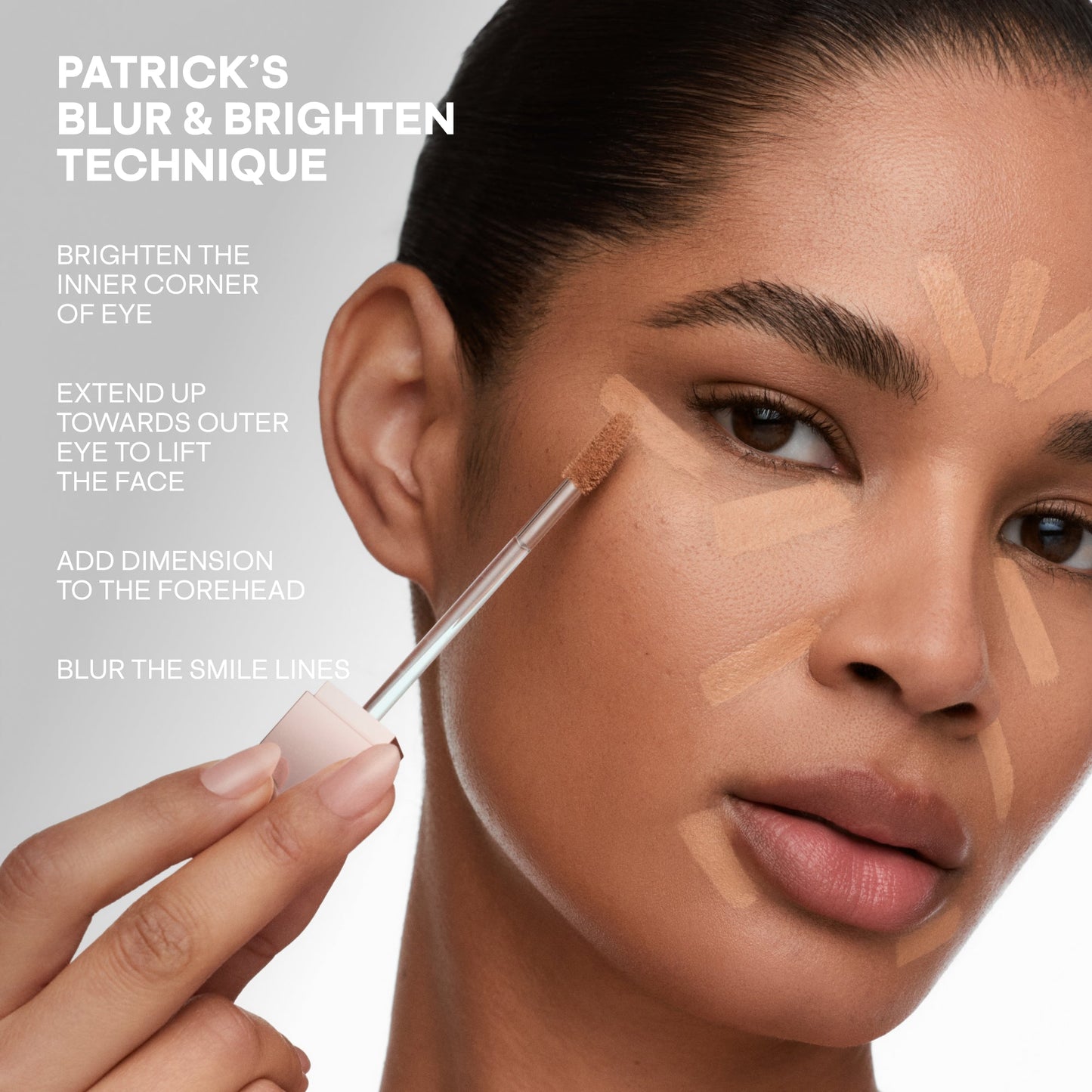 Model applying creamy, medium beige concealer with dewy finish to face for brightening and contouring.