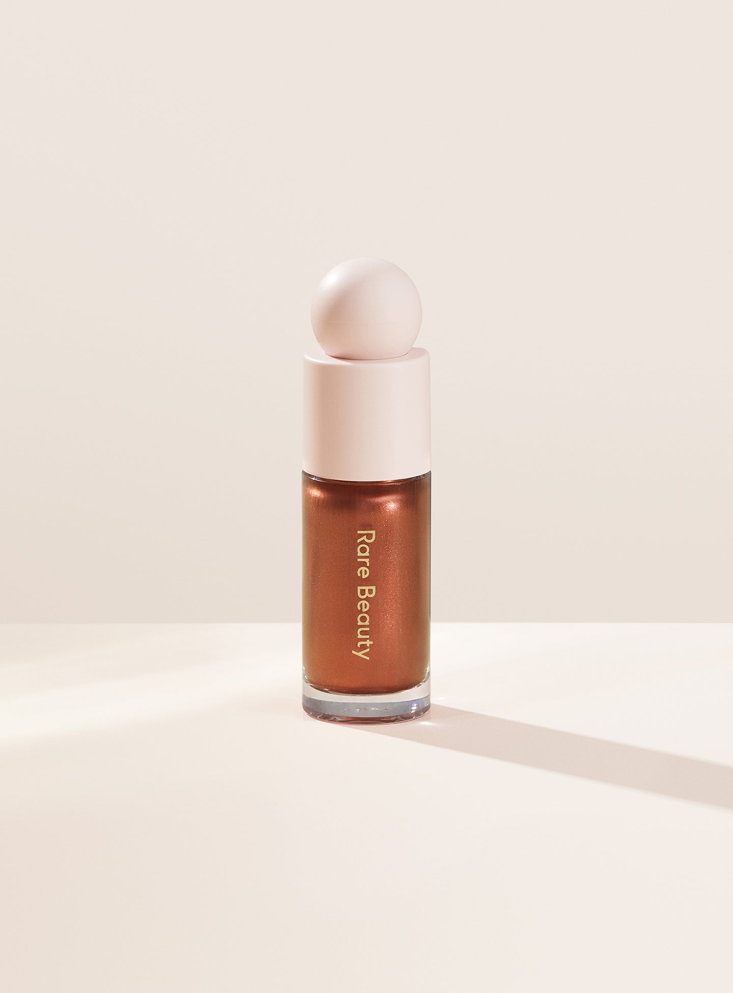 Reflect| Rare Beauty's Positive Light Liquid Luminizer in the deep bronze shade "Reflect."