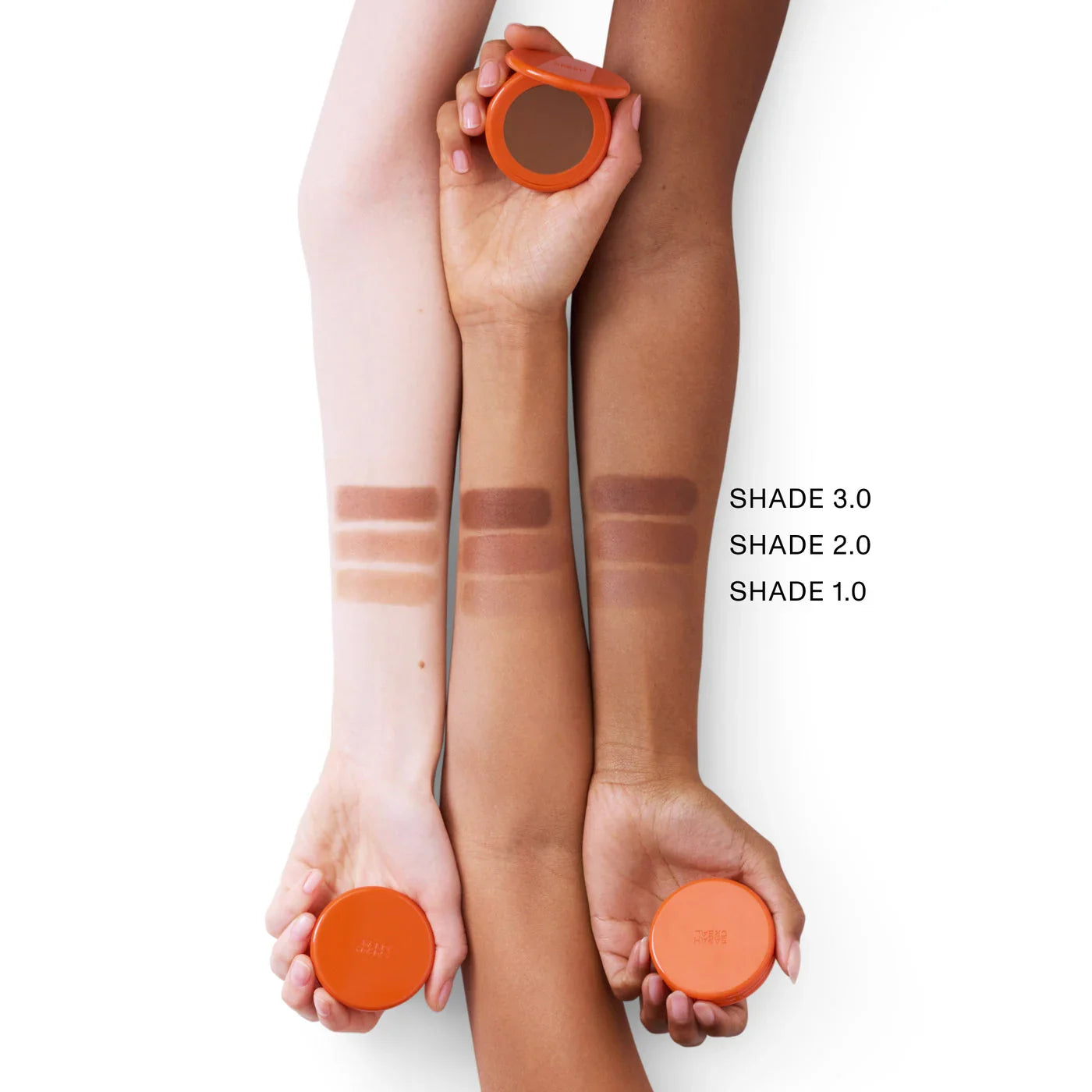 Three arms showing bronzer swatches in shades 1.0, 2.0, and 3.0, luxe orange compact