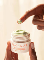 Hand holding Peach & Lily Matcha Pudding Antioxidant Cream with silky green texture