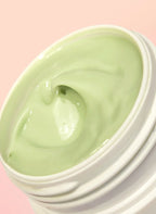 Luxurious light green creamy skincare mask in white jar on pink background, Wylde Grey