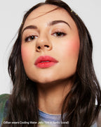 Woman with natural makeup and coral Cooling Water Jelly Tint on lips and cheeks