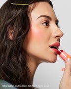 Woman applying coral lip tint, Cooling Water Jelly Tint Spritz, close-up beauty shot