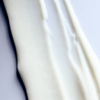 Close-up of white goop with soft folds on a light gray background