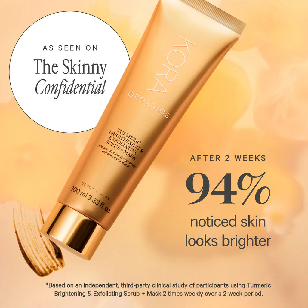 KORA Organics Turmeric Brightening Exfoliating Mask with golden tube and sleek metallic cap on peach background, highlighting glowing skincare results.
