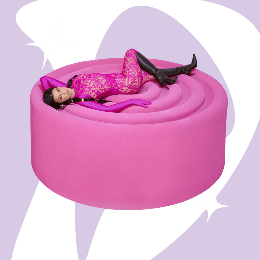 Kourtney laying on top of an oversized pink gummy with lemme debloat shape in the background