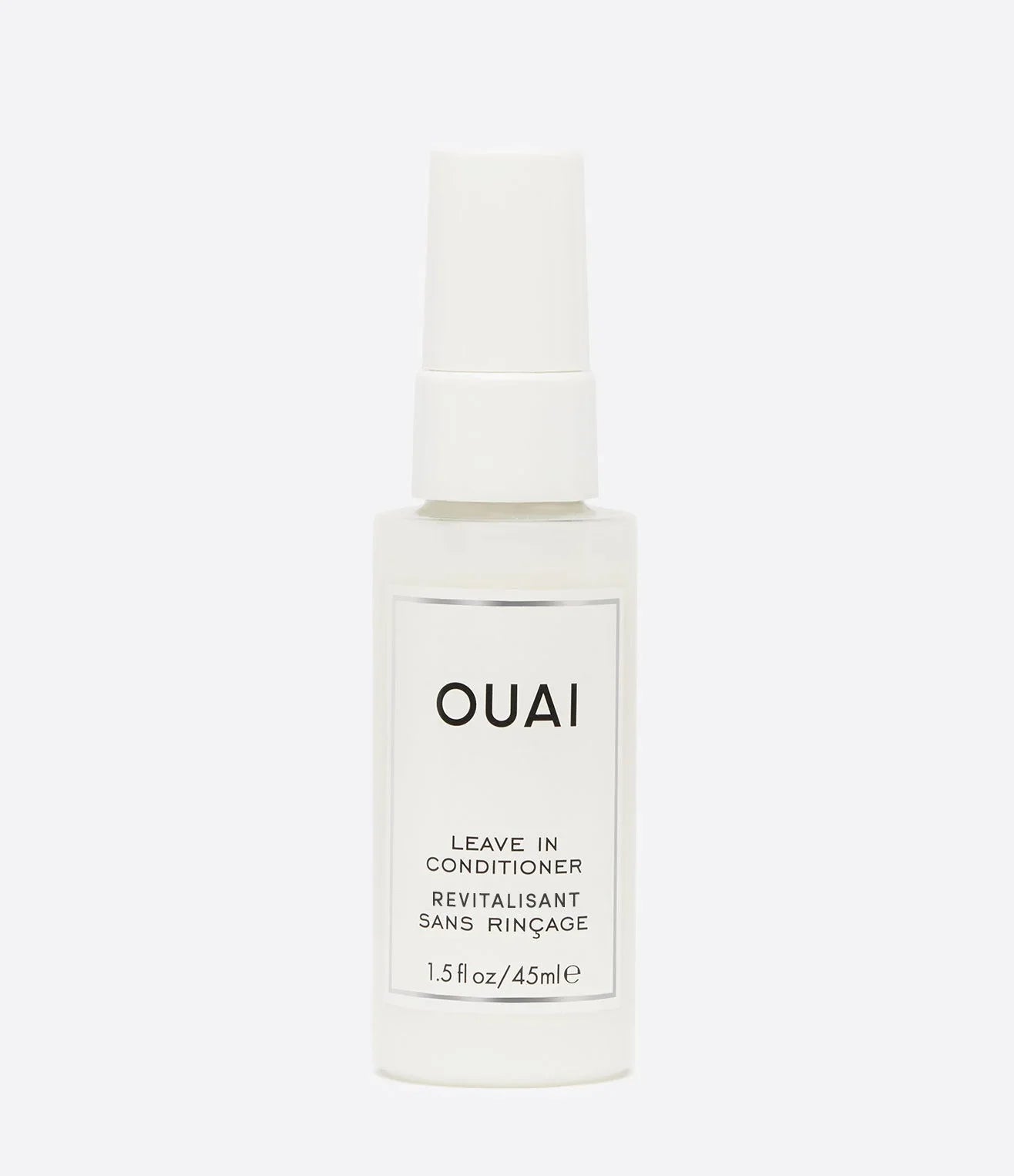 OUAI Leave-In Conditioner travel size bottle with sleek white packaging on a grey background