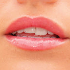 A model wearing the Tower 28 Beauty ShineOn Lip Jelly in the shade Coconut on her lips. [Coconut]