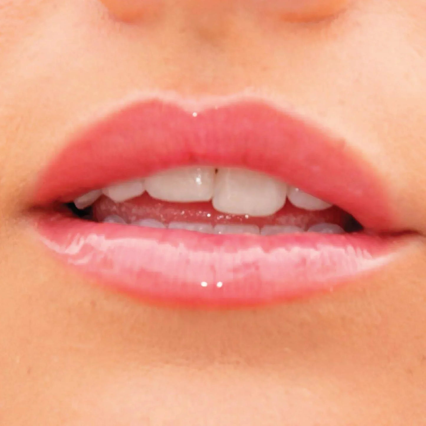 A model wearing the Tower 28 Beauty ShineOn Lip Jelly in the shade Coconut on her lips. [Coconut]