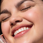 A person wearing the Tower 28 Beauty ShineOn Lip Jelly in the shade Magic on her lips. [Magic]