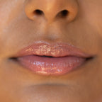 A model wearing the Tower 28 Beauty ShineOn Lip Jelly in the shade Pistachio on her lips. [Pistachio]
