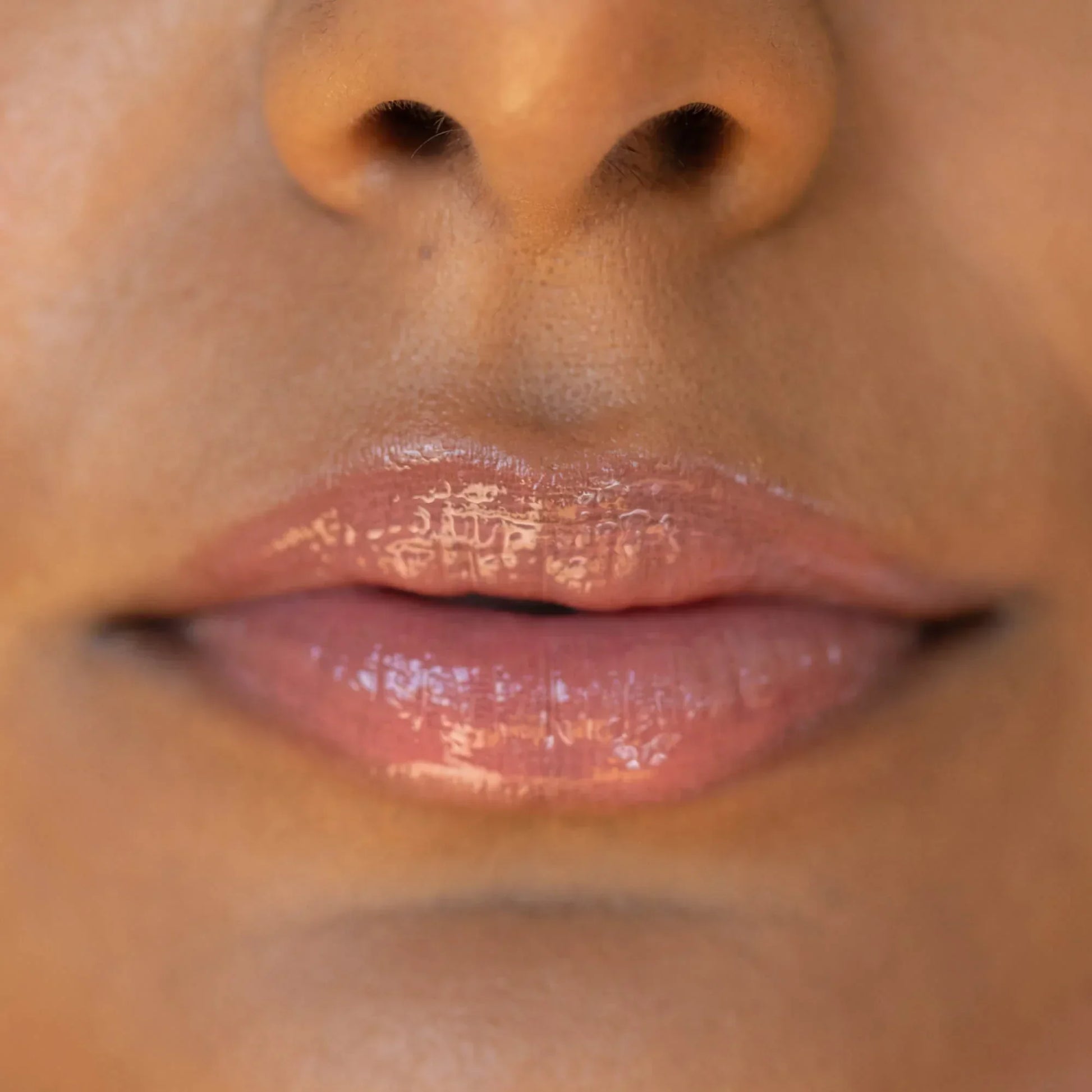 A model wearing the Tower 28 Beauty ShineOn Lip Jelly in the shade Pistachio on her lips. [Pistachio]