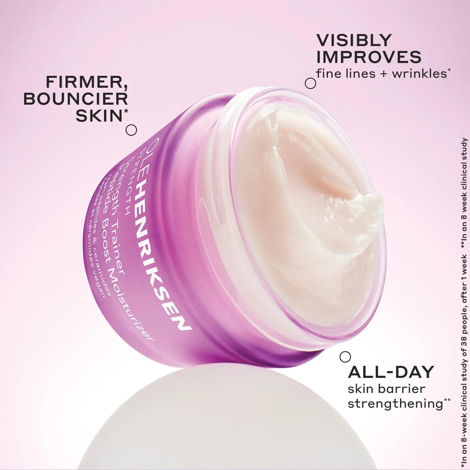 Luxurious purple jar of Ole Henriksen Strength Trainer Peptide Boost Moisturizer with creamy texture on a pink background, highlighting skin firming, wrinkle improvement, and all-day barrier support.