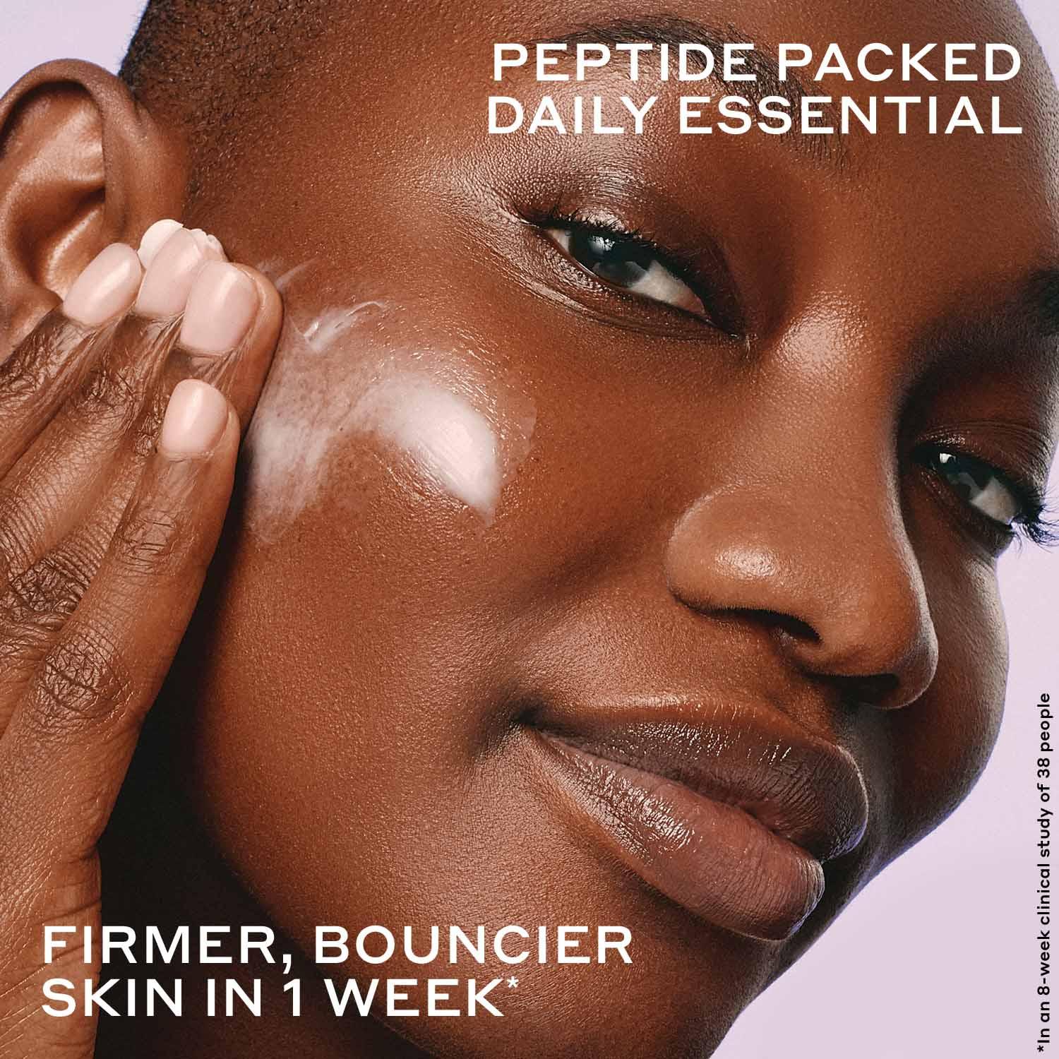 Woman applying creamy peptide moisturizer for firmer, glowing skin, Wylde Grey skincare