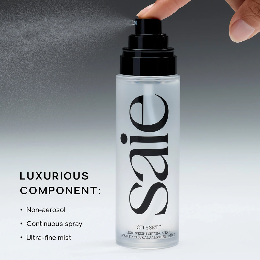 Saie CitySet Setting Spray showcasing ultra-fine mist, sleek frosted bottle, luxury beauty