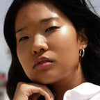 A model wearing the Tower 28 Beauty ShineOn Lip Jelly in the shade Chill on her lips. [Chill]