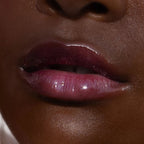 A model wearing the Tower 28 Beauty ShineOn Lip Jelly in the shade Fear Less on her lips. [Fear Less]