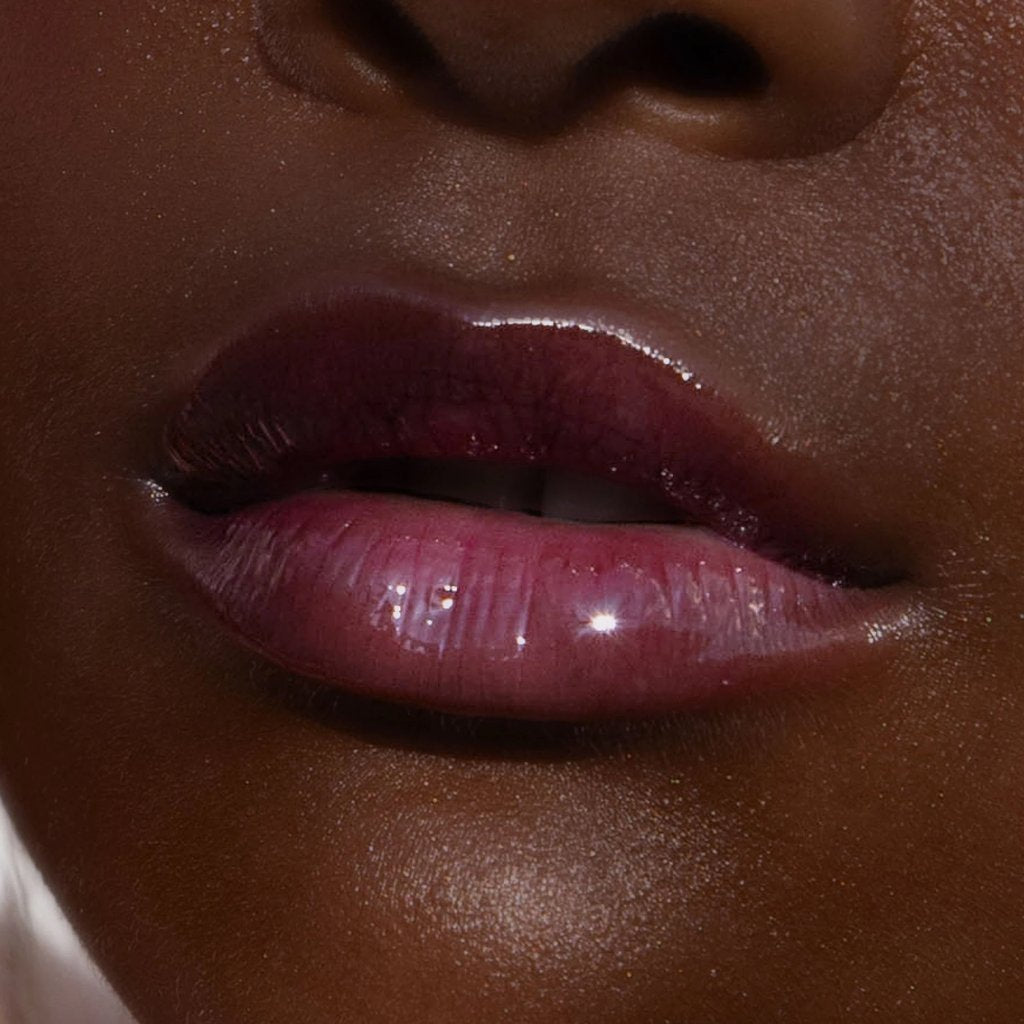 A model wearing the Tower 28 Beauty ShineOn Lip Jelly in the shade Fear Less on her lips. [Fear Less]