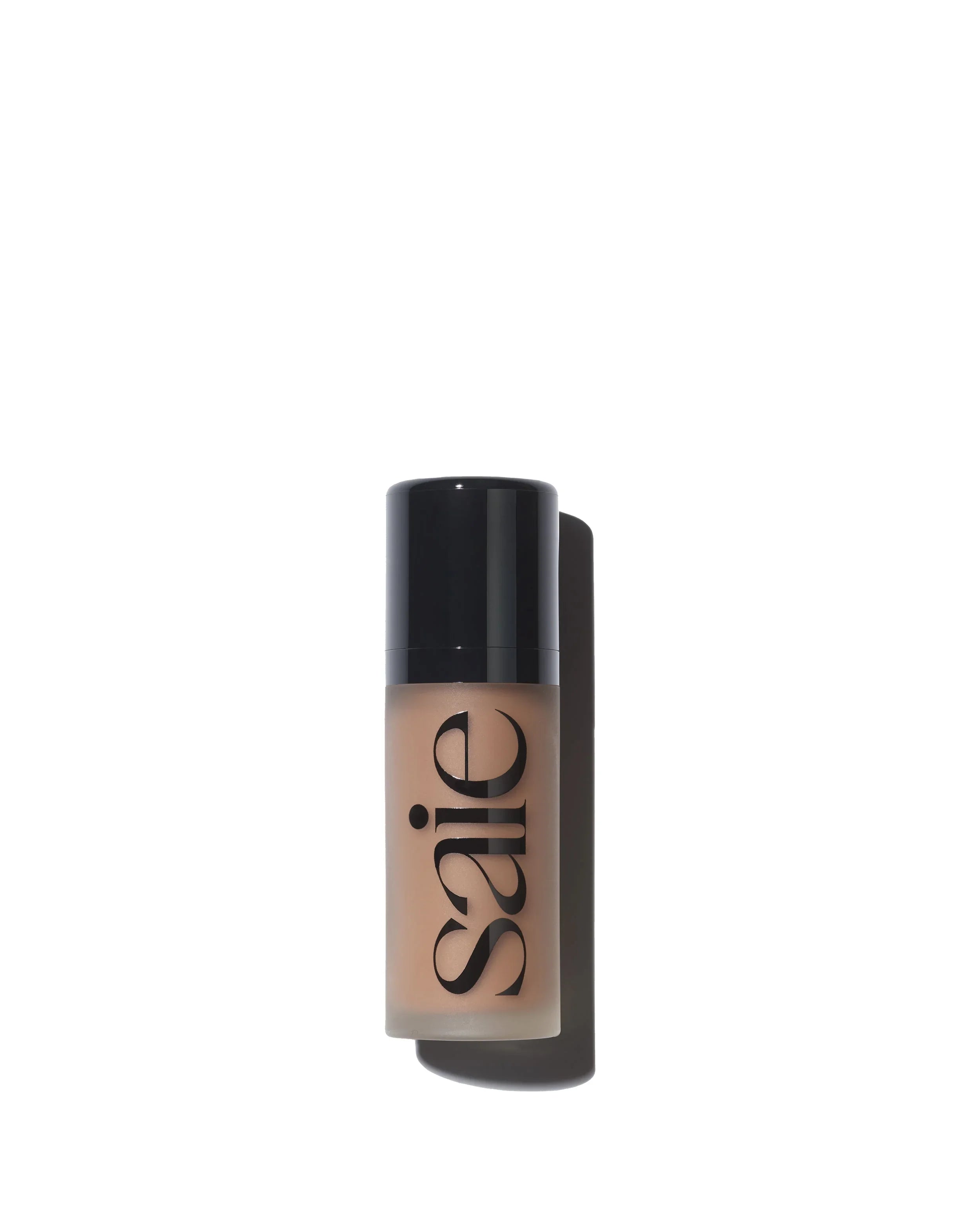 Saie Beauty foundation bottle in sand shade with sleek black cap and creamy beige texture
