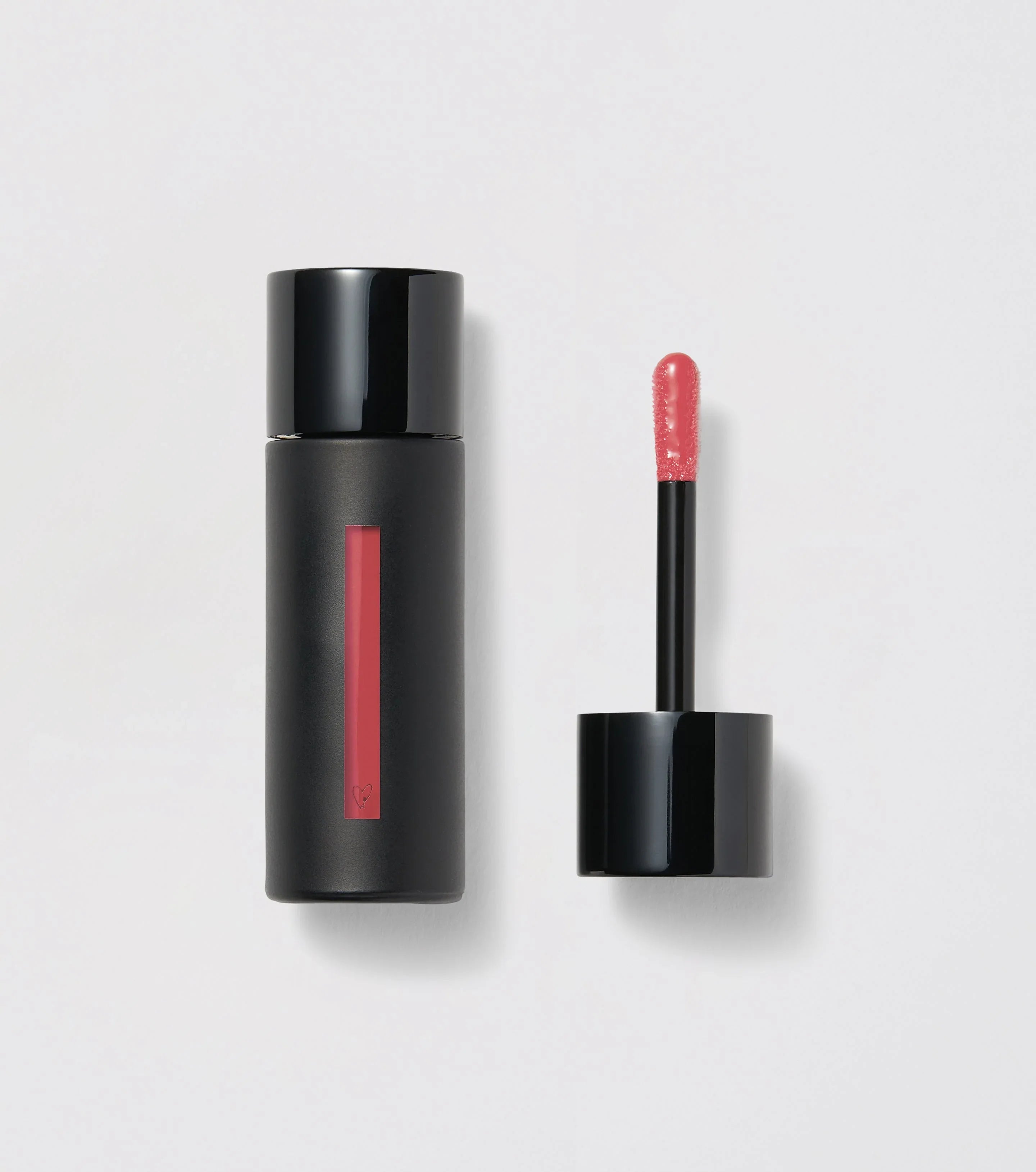Sleek black lip gloss tube with glossy pink color and applicator, luxury beauty at Wylde Grey