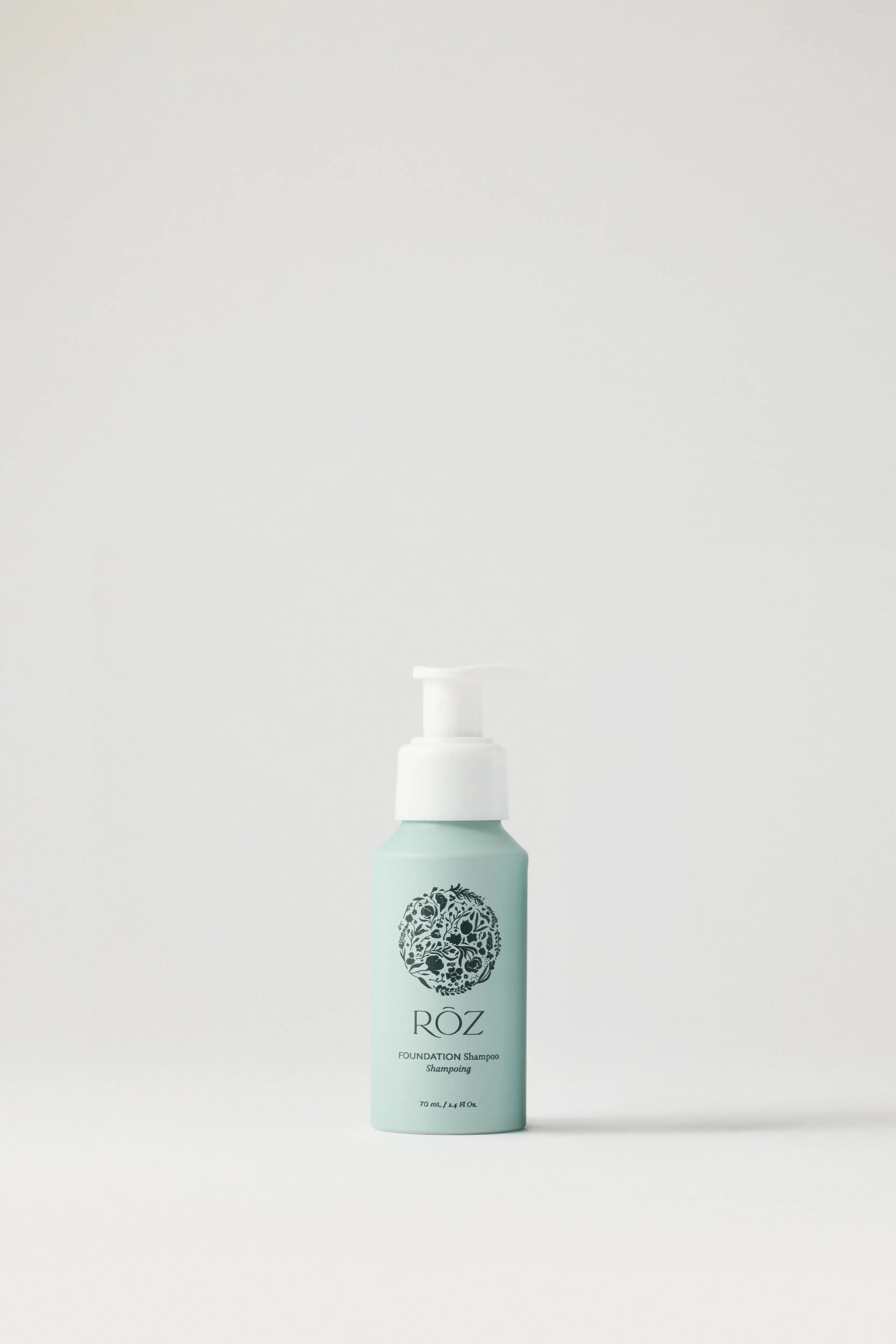 ROZ Foundation Shampoo mini travel bottle in mint green with a white pump, on a clean white background, available at Wylde Grey.