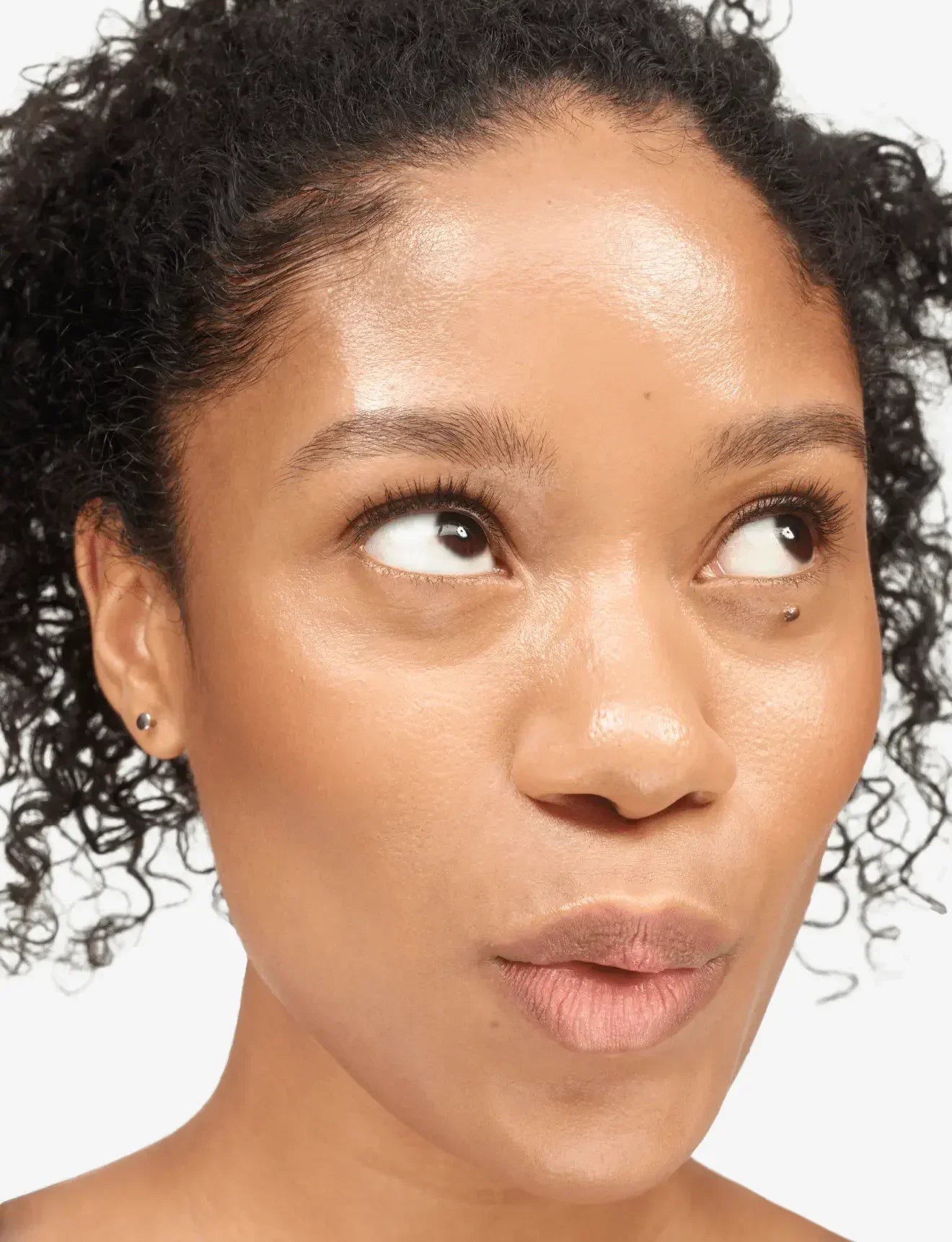 Model with dewy, radiant skin and natural makeup highlighting smooth, glowing texture