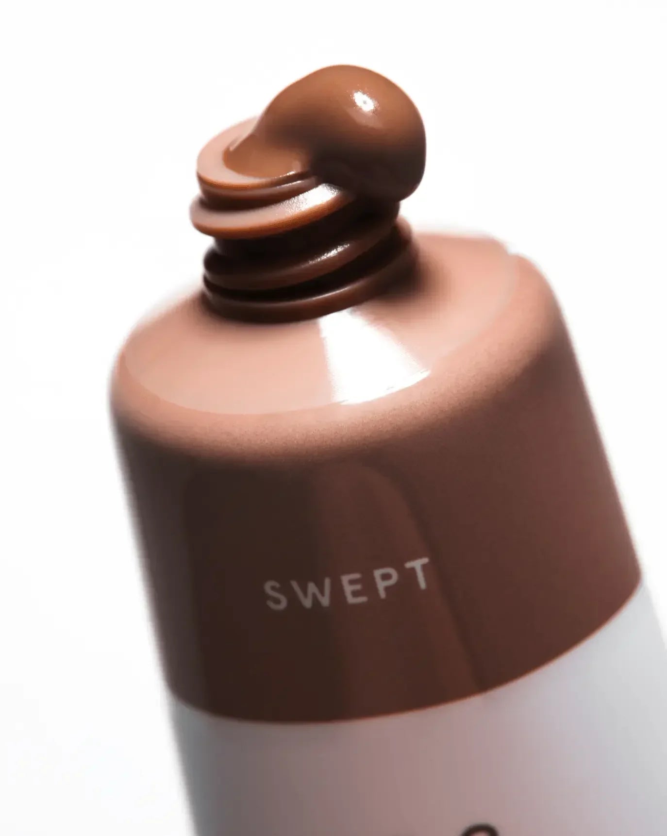 Creamy mauve liquid blush with dewy finish, shown from open tube labeled SWEPT.