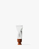 Tube of Cloud Paint blush in warm terracotta shade with creamy, blendable texture on white background