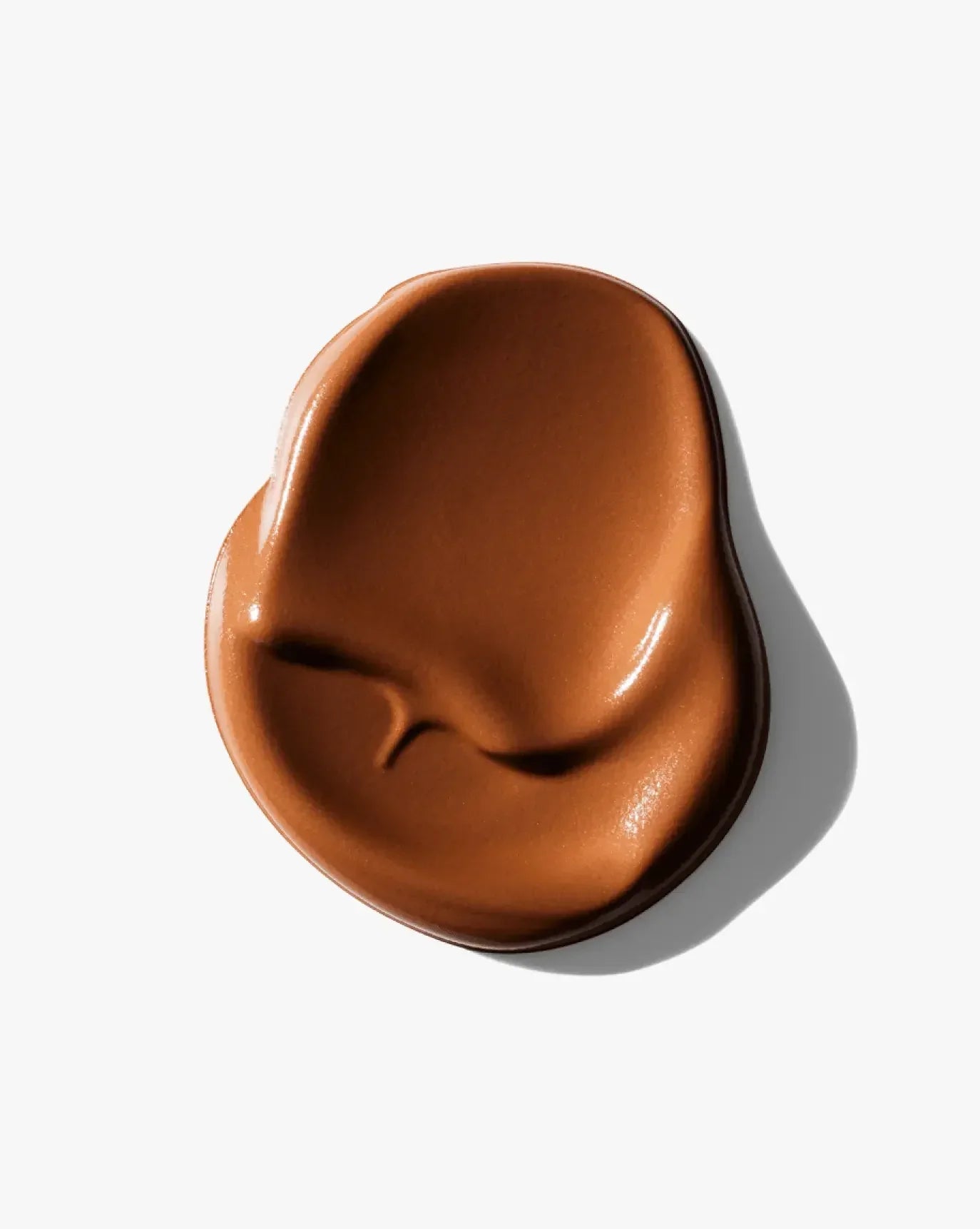 Rich caramel brown cream blush with a smooth, dewy finish on a white background
