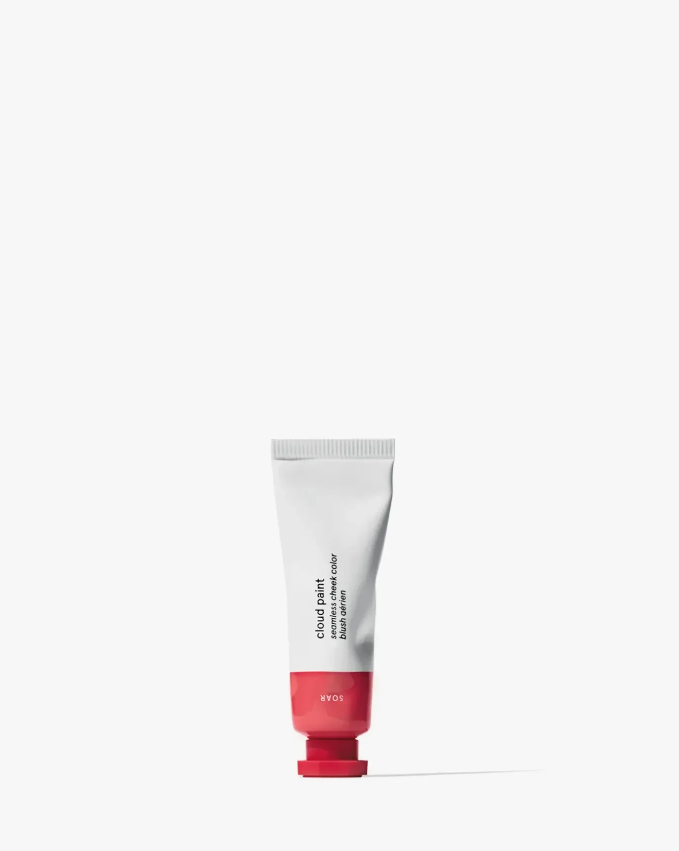 Creamy pink liquid blush tube with dewy finish on a white background