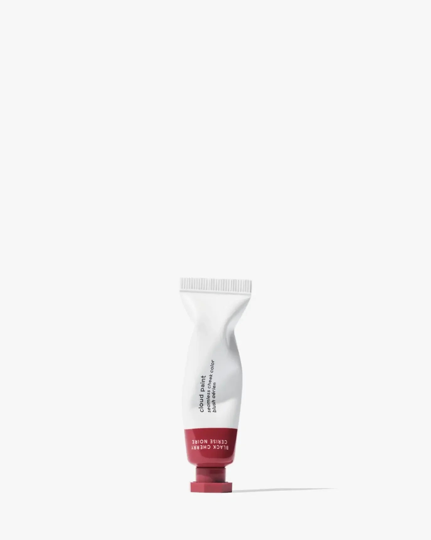 Soft pink cream blush in a sleek tube with a dewy finish on a white background