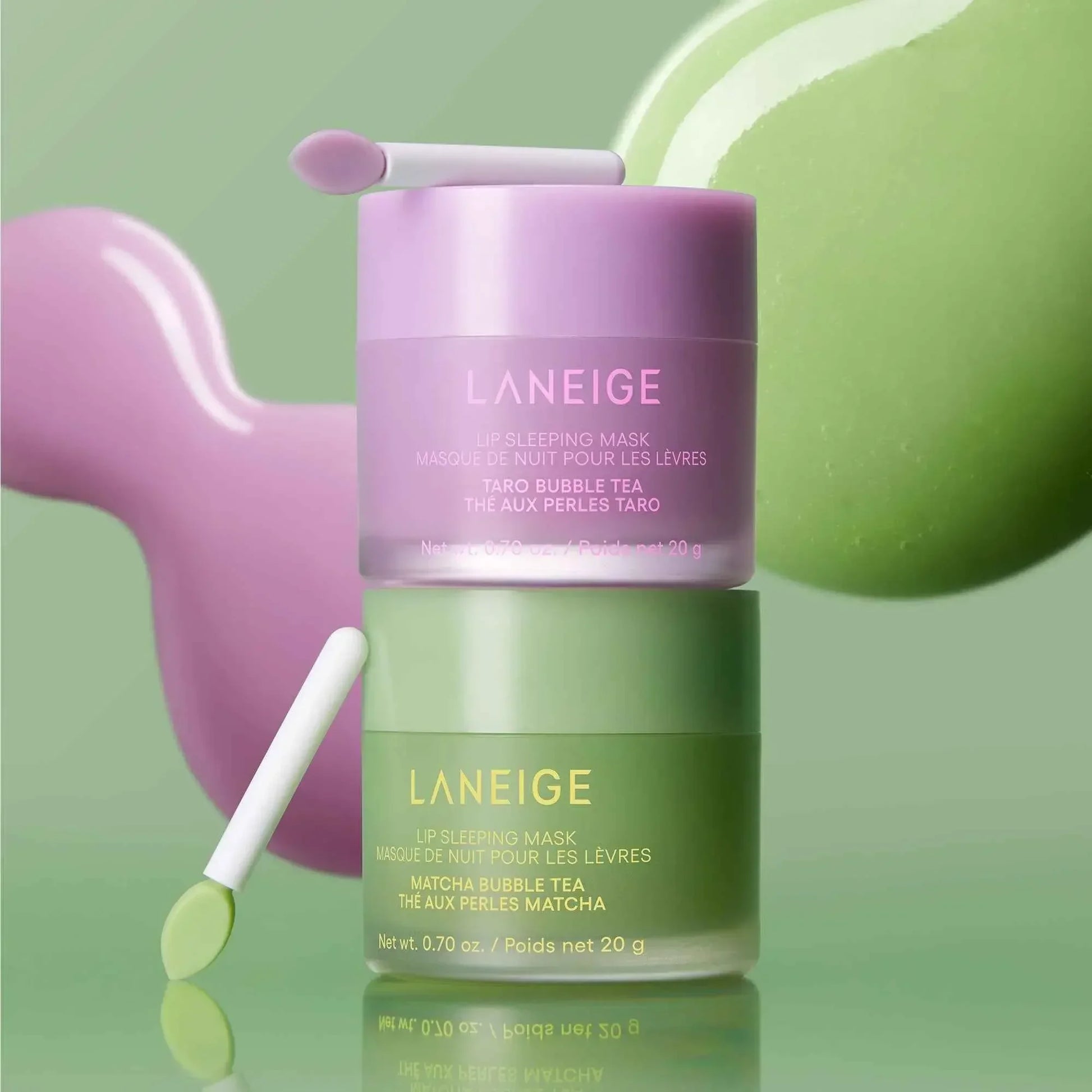Luxurious Laneige lip sleeping masks in pastel purple and green jars with creamy, glossy texture.