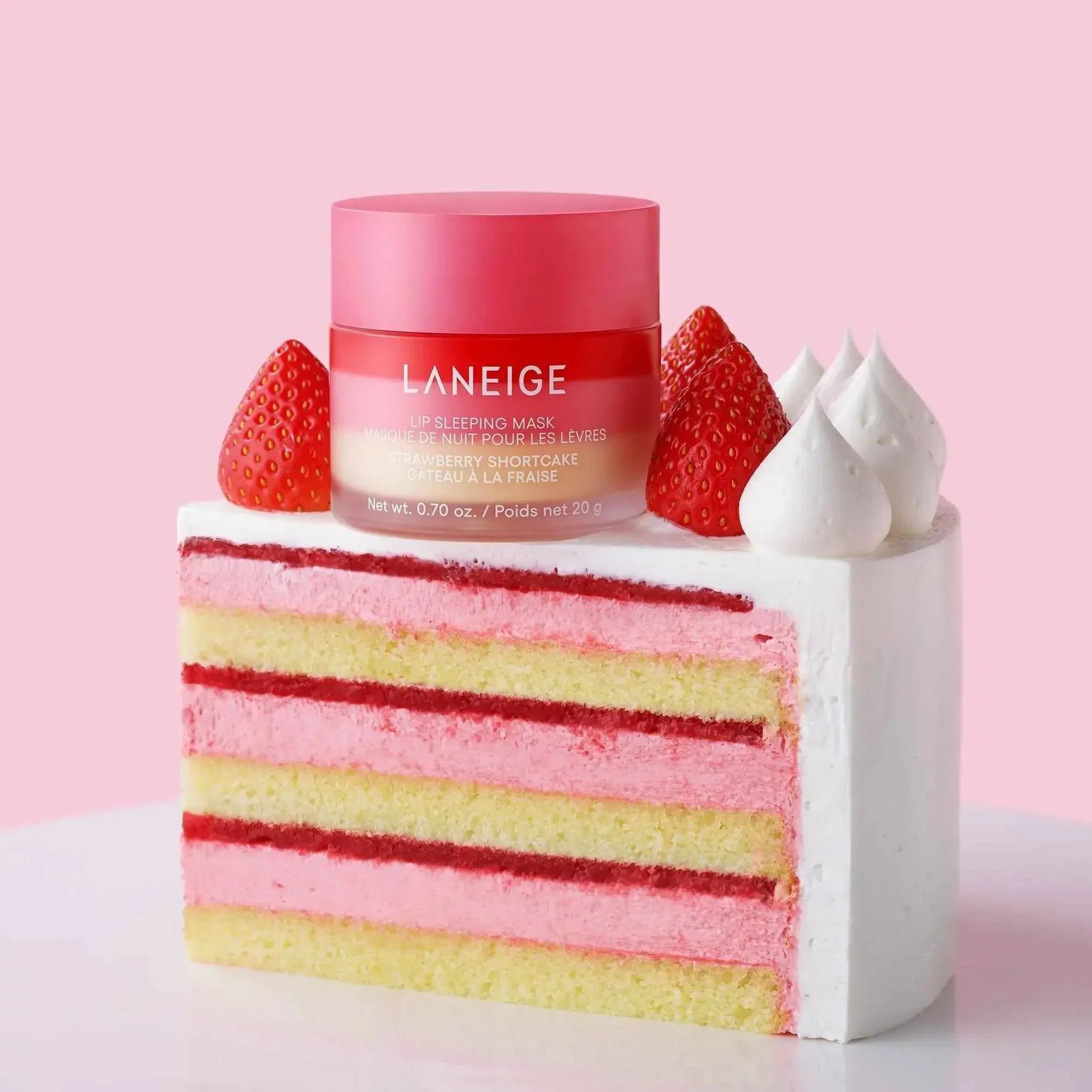 Luxurious pink lip sleeping mask with creamy texture on a slice of strawberry shortcake
