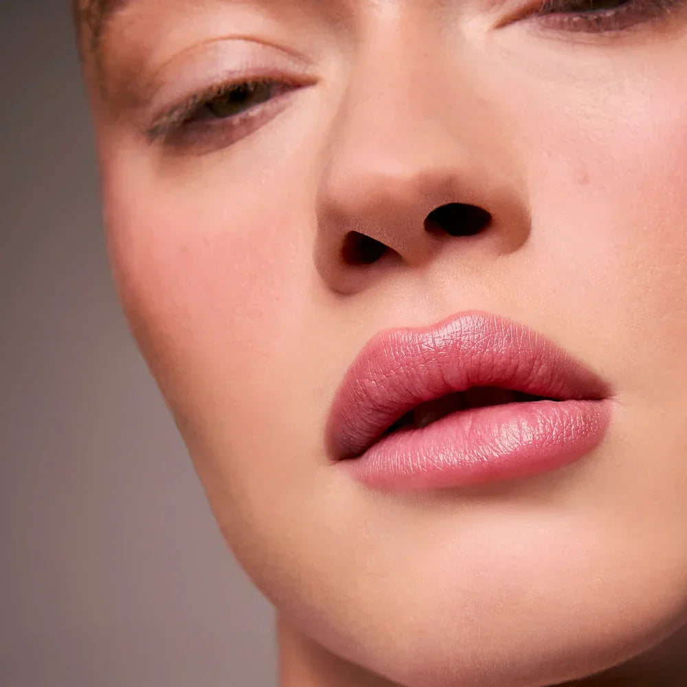 Close-up of model with smooth skin and soft rose-pink lipstick, Wylde Grey beauty focus