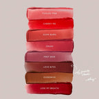 Luxurious Wylde Grey lipstick swatches in pink, red, mauve, and nude shades on a neutral background.